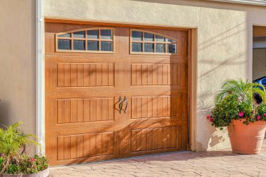 Brown glass paned wooden garage door of home in Huntington Beach California