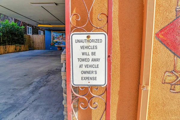 No Parking warning sign for unauthorized vehicles in Huntington Beach California