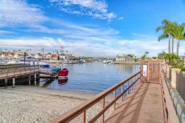 Boat docks in Huntington Beach California with sea and cloudy blue sky views