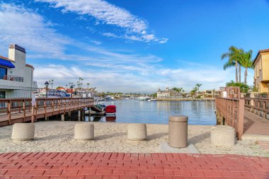 Scenic sea with boat docks under vibrant blue sky in Huntington Beach California