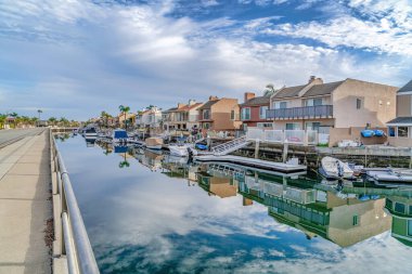 Huntington Beach California scenery with homes overlooking the road and canal