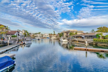 Cloudy blue sky over stunning view of the sea with boats in Huntington Beach
