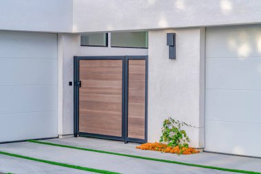 Gate and driveway with grasses at home exterior in Huntington Beach California