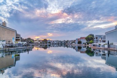 Sea and houses at a neighborhood in Huntington Beach California at sunset