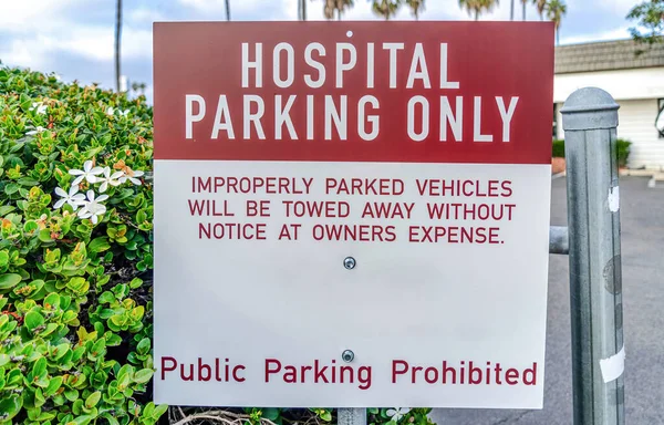 Hospital Parking Only road sign with leaves background in San Diego California