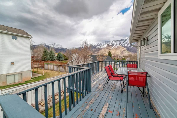 Balcony with snowy mountain cloudy sky and homes in the neighborhood views