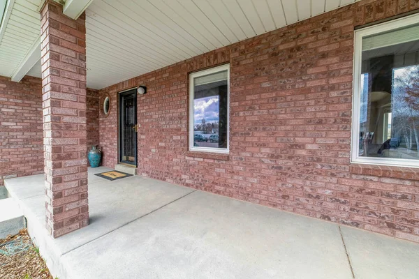 Amplio y abierto envolvente porche de hormigón de casa con pared exterior de ladrillo — Foto de Stock