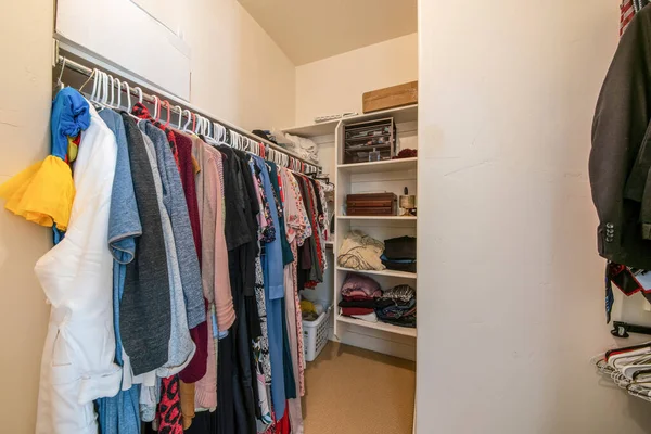 Pequeño walk in closet con varilla de ropa y estantes — Foto de Stock