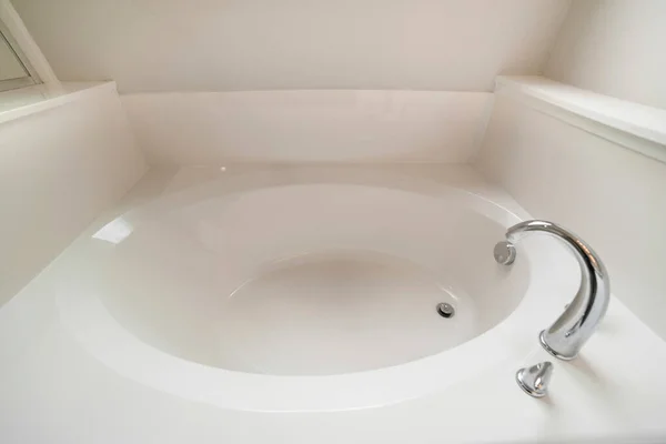 Interior of a bathroom with bathtub, drainage and faucet