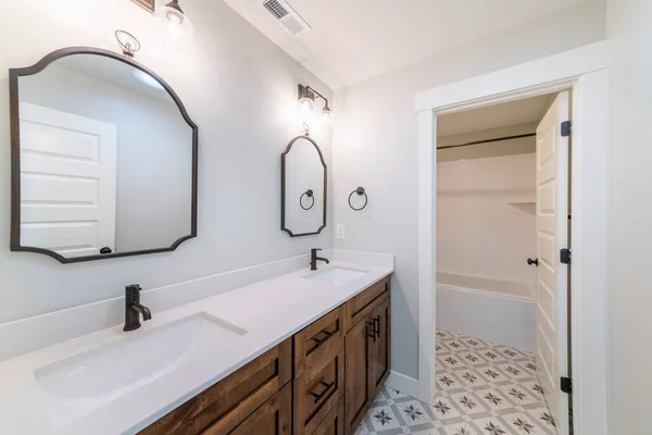 Bathroom interior with vanity sink and separate bathtub