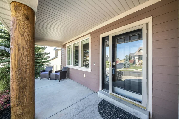 Front porch of a house with engineered wood siding wall and log column post — Stock Photo, Image