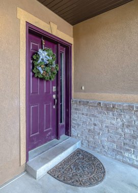 Mor ön kapısı çelenkle süslenmiş dikey ev cephesi