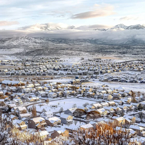 Square Picturesque landscape of neighborhood surrounded by mountain and snow in winter