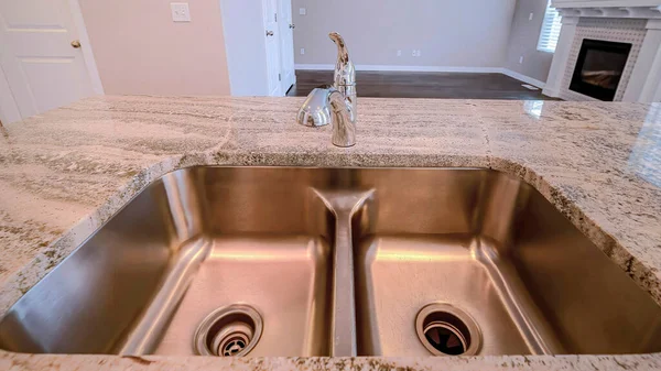 Pano Stainless steel sink with double basin on a kitchen island of newly built house