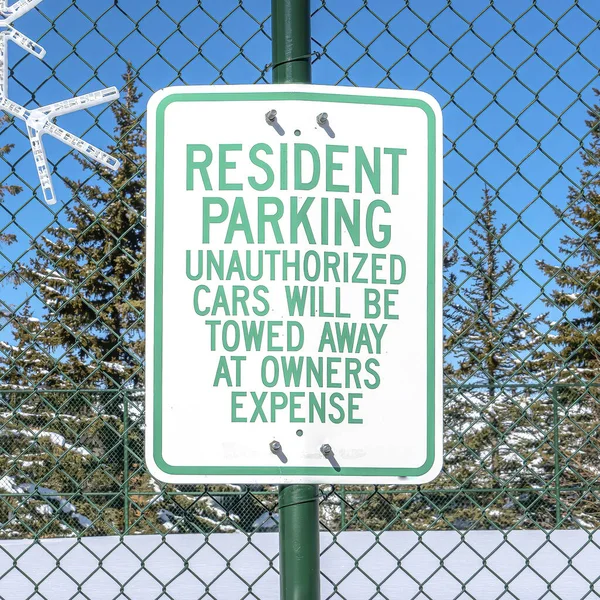 공원 도시에 있는 녹색 철조망에 걸려 있는 눈송이와 주민 파킹 표지판 — 스톡 사진