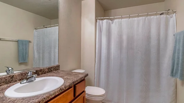 Pano Tuvalet ve makyaj odası banyonun içinde fayanslı zemin ve beyaz duş perdesi var. — Stok fotoğraf