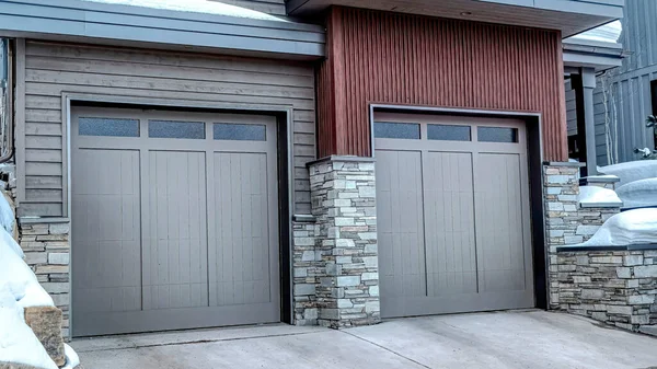 Pano garaje para dos coches con puertas de cristal gris cristal en la fachada del hogar en invierno — Foto de Stock