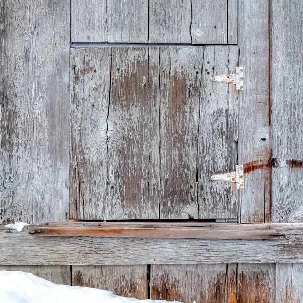 Square Close up of wooden building exterior with small square hinged window in winter — Stock Photo, Image