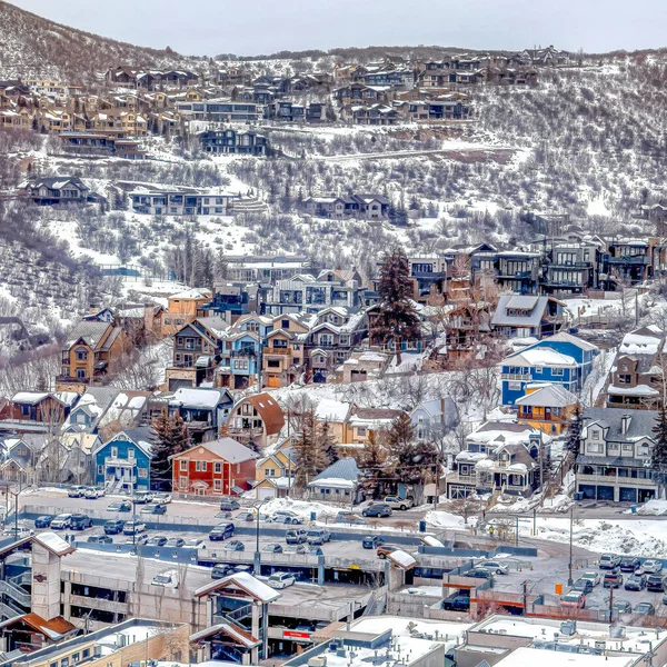 Square Aerial view of houses and buildings in the residential area of a snowy mountain