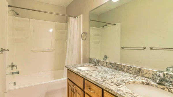 Pano Bathroom with double sink on marble countertop with cabinets and huge mirror — ストック写真