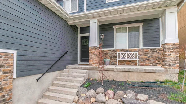 Pano Stairs going up the porch of home with gray front door and window at the facade — Stock Photo, Image