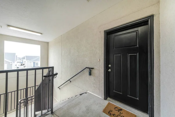 House interior upstairs with metal railings and wall mounted handrail