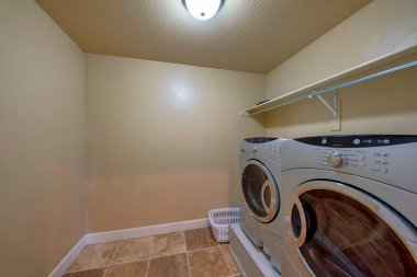 Çamaşır odasının içi kirli çamaşırlarla dolu. Ahşap bir temel podyumun tepesinde.