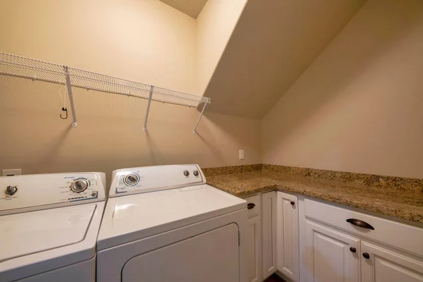 Un mueble de lavandería renderizado está diseñado con una lavadora y un  amplio espacio de almacenamiento para detergentes.