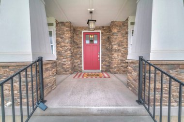 Taş duvarları olan bir evin ön girişi.