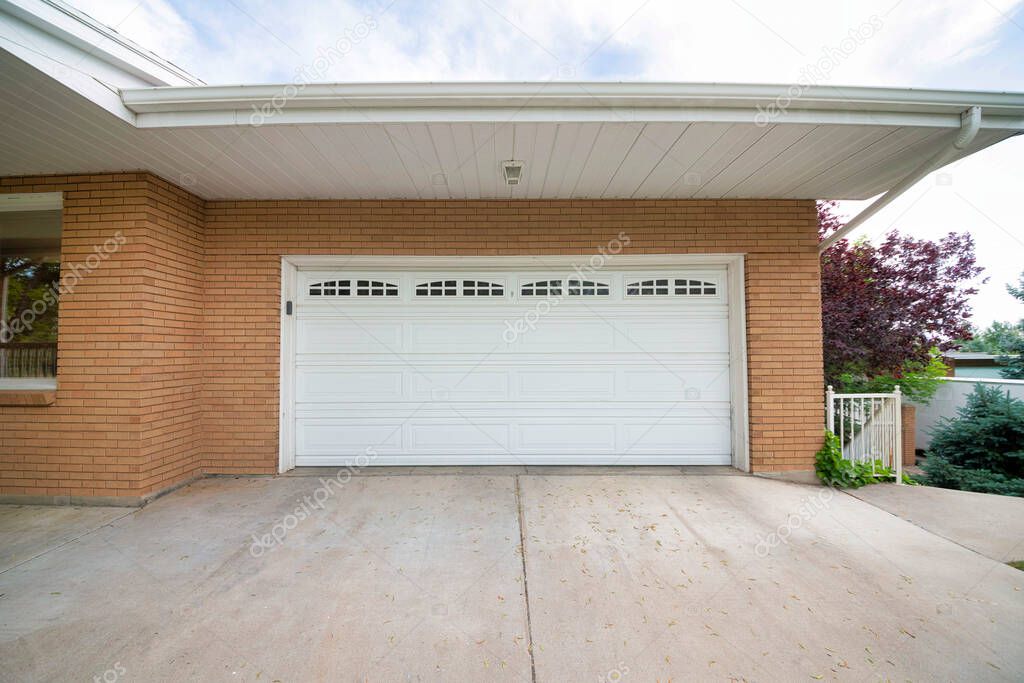 White sectional garage door with glass panels at the top