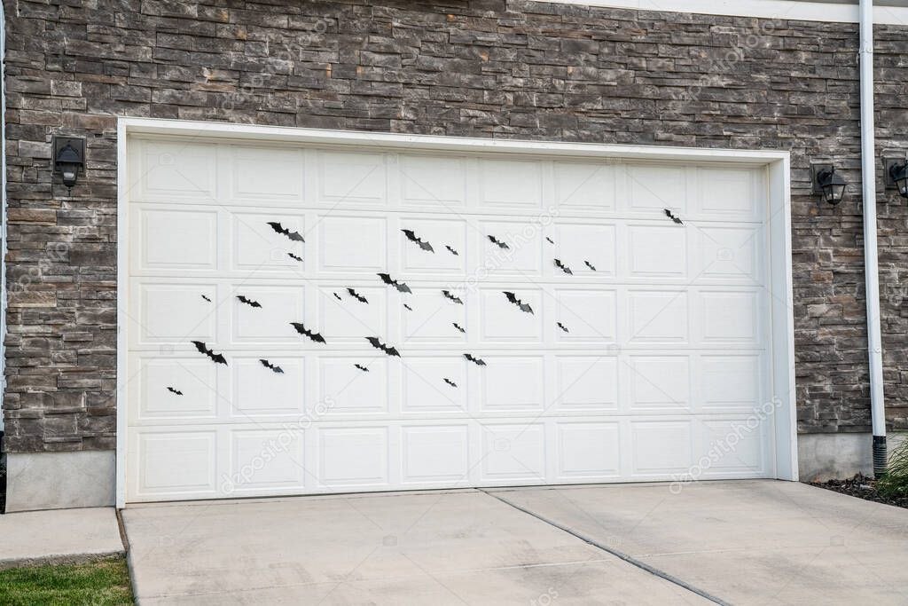 White sectional garage door with bat stickers displays