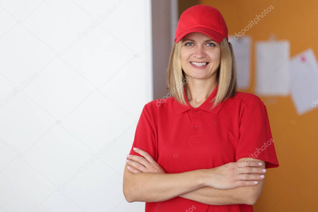 Portrait of smiling courier woman in red uniform