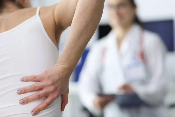 Woman complains of back pain to doctor. — Stock Photo, Image