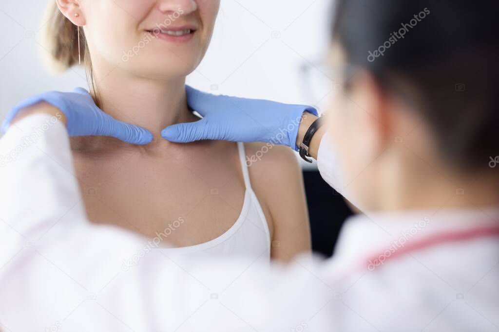Doctor examines the patients thyroid gland closeup