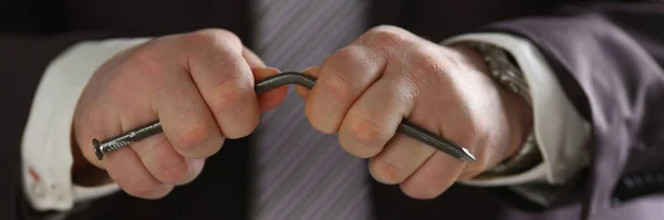 Konzentriertes Foto auf Männerhände, die Metallnagel biegen — Stockfoto