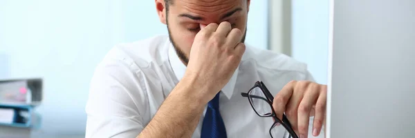 Yorgun genç ofis çalışanı gözlerine masaj yapıyor. — Stok fotoğraf