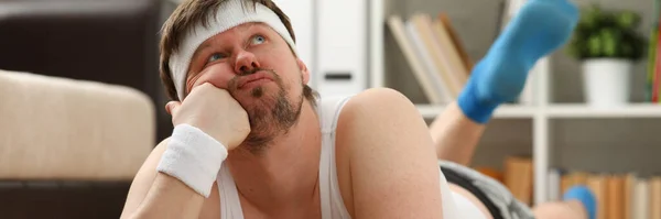 Bored man lying on the floor at home — Stock Photo, Image