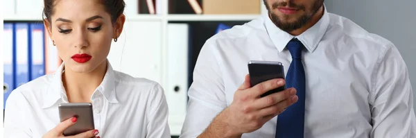 Business colleagues using modern smartphones at work — Stock Photo, Image
