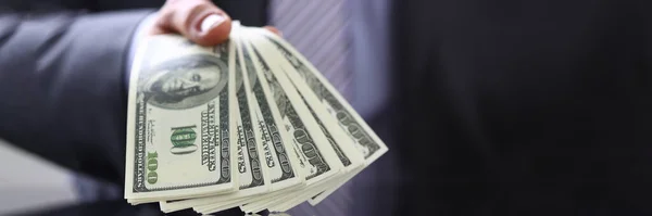Hombre de negocios rico demostrando manojo de billetes en la mano — Foto de Stock