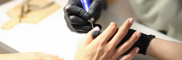 Specialist processes the skin around the nail — Stock Photo, Image