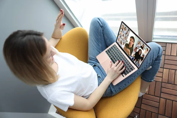 Woman conducts online broadcast with colleagues closeup