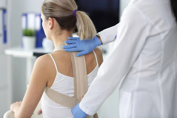 Doctor fixes posture corrector to patient closeup — Stock Photo, Image