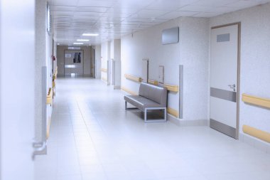 Beyaz kapıları olan hafif hastane koridoru.