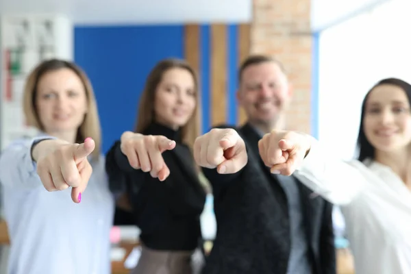 Business people team pointing with index fingers at you closeup