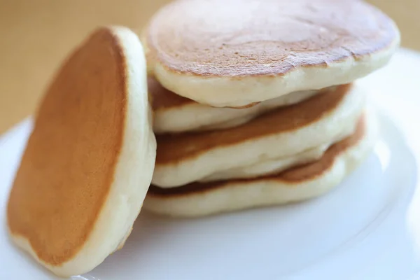 Portion of cooked flour pancakes lying on white plate closeup — Stock Photo, Image