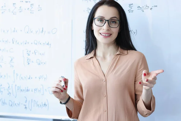 Portrait of woman teacher with glasses near school board — Stock Photo, Image