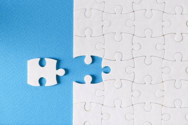 Mavi arkaplanda ayrı ayrı duran yapbozun son parçası