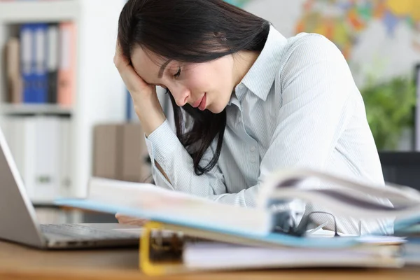 Tired exhausted young woman sits at laptop in office — Stock Photo, Image