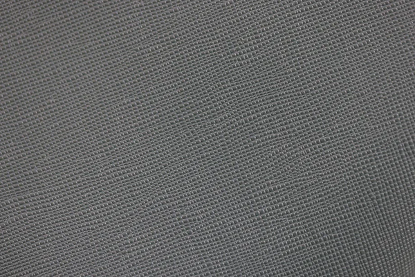 Textur av grått läder tyg, mörk färg ton av tyg mönster. — Stockfoto