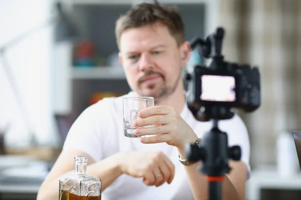 Video blogger pije alkohol sám před kamerou — Stock fotografie